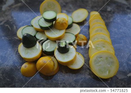 Yellow and green zucchini, cut into circles Yellow and green zucchini, cut into circles 54771825