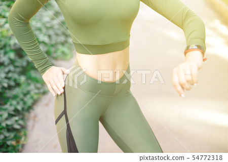Close-up athletic female body slim elegant waist of a stylish fitness model with perfect figure Close-up athletic female body slim elegant waist of a stylish fitness model with perfect figure 54772318