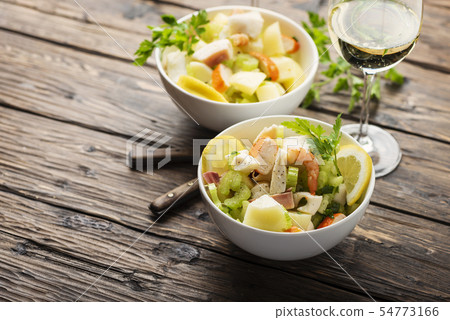 salad with seafood, potato and celery 54773166