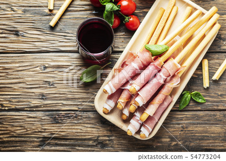 Italian antipasto with brad sticks and pork ham 54773204