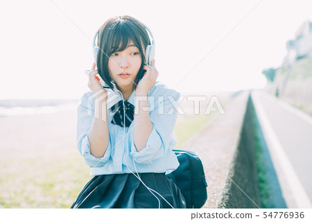 High school girl listening to music near the sea 54776936