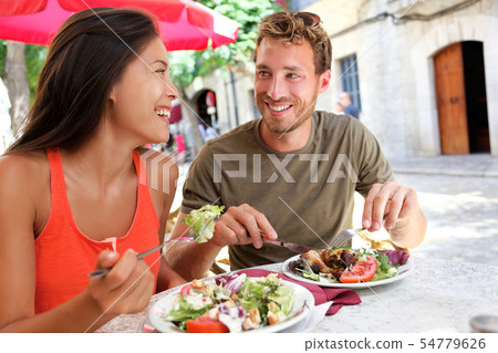 Restaurant tourists couple eating at outdoor cafe Restaurant tourists couple eating at outdoor cafe 54779626