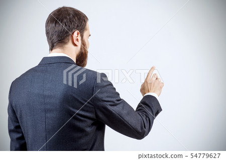 Businessman pointing to something or touching by forefinger. Businessman pointing to something or touching by forefinger. 54779627