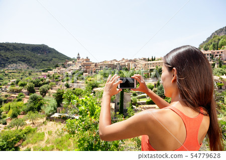 Tourist taking picture of Deia Village in Mallorca Tourist taking picture of Deia Village in Mallorca 54779628