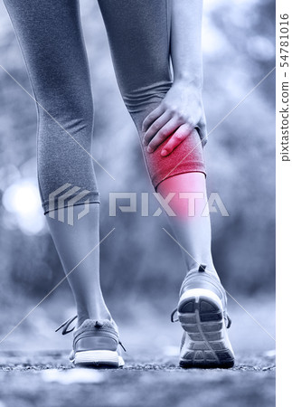 Muscle injury - woman running clutching calf muscle Muscle injury - woman running clutching calf muscle 54781016