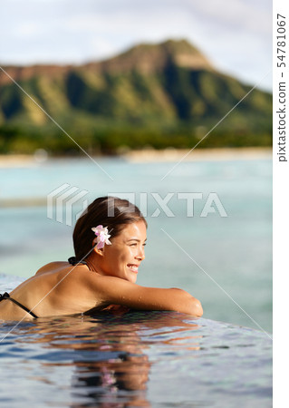 Travel vacations woman on holiday at beach resort 54781067