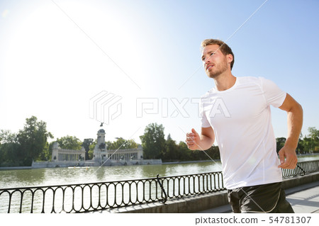 Jogging man running in city park El Retiro Madrid 54781307