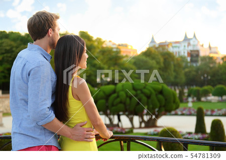 Romantic couple embracing enjoying view in park Romantic couple embracing enjoying view in park 54781309