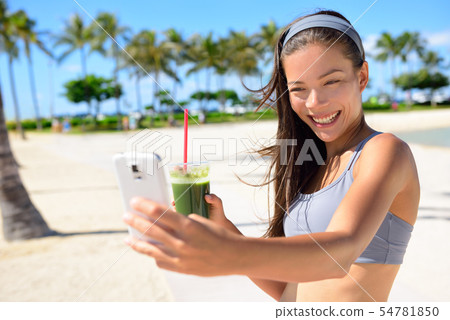 Fitness selfie woman drinking green smoothie 54781850