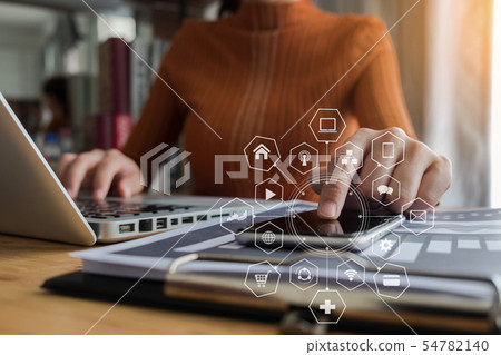 women is using smart phone at office. women is using smart phone at office. 54782140