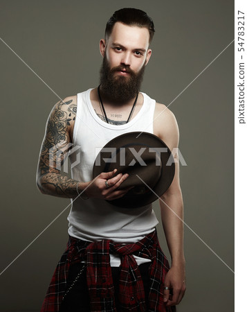 Tattooed handsome Bearded Man with Hat Tattooed handsome Bearded Man with Hat 54783217
