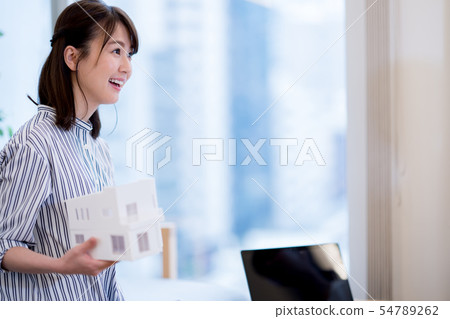 A woman with a housing model A woman with a housing model 54789262