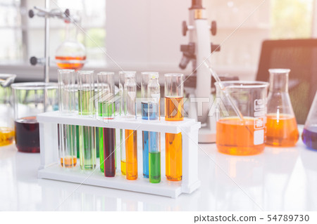 Test tubes with colorful liquids in holder on table in laboratory. Test tubes with colorful liquids in holder on table in laboratory. 54789730