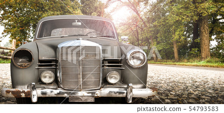 old car in a country road 54793583
