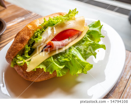 Ham sandwiches on white dish 54794108