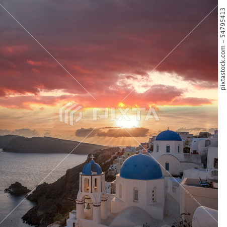 Oia village against sunset on Santorini in Greece 54795413
