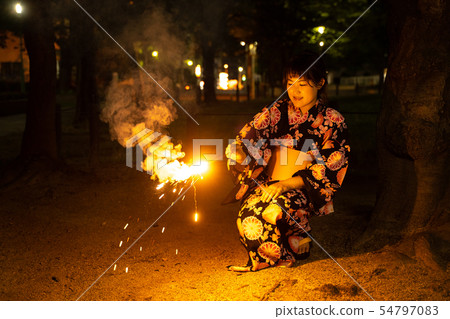 Woman doing fireworks in yukata 54797083