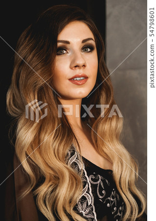 Young pretty woman, wearing transparent black peignoir night gown in dark room Young pretty woman, wearing transparent black peignoir night gown in dark room 54798601