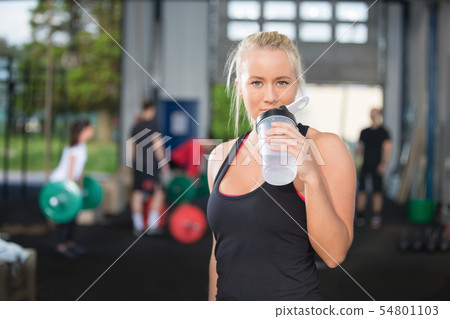Woman drinking water at fitness gym center Woman drinking water at fitness gym center 54801103