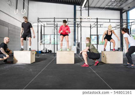 Crossfit group trains box jump 54801161