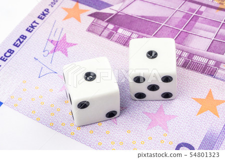 Two white dices laying on 500 euro banknote 54801323
