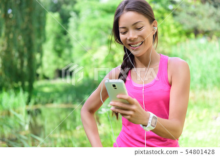 Woman runner sharing running data on social media Woman runner sharing running data on social media 54801428