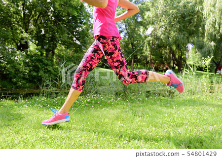 Female runner running shoes and legs in city park Female runner running shoes and legs in city park 54801429