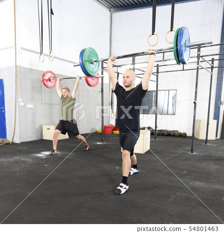 Clean and jerk workout at fitness gym center 54801463