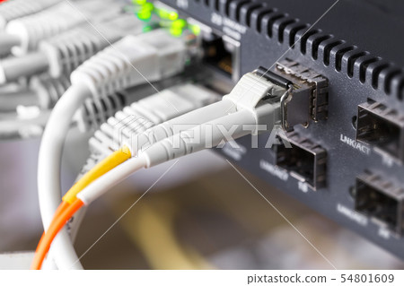 Close-up of high speed fiber network switch and cables in datacenter 54801609