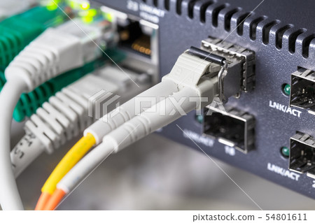 Close-up of high speed fiber network switch and cables in datacenter 54801611