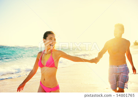 Laughing romantic couple summer vacation beach fun Laughing romantic couple summer vacation beach fun 54801765