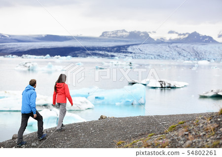 Hiking couple on Iceland Jokulsarlon glacier lake Hiking couple on Iceland Jokulsarlon glacier lake 54802261