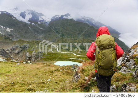 Hiking hiker on trek in mountains with backpack 54802660