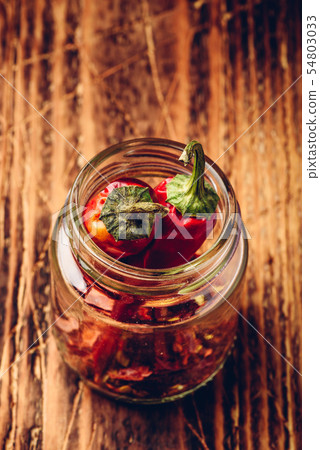 Two dried red chili peppers in jar Two dried red chili peppers in jar 54803033