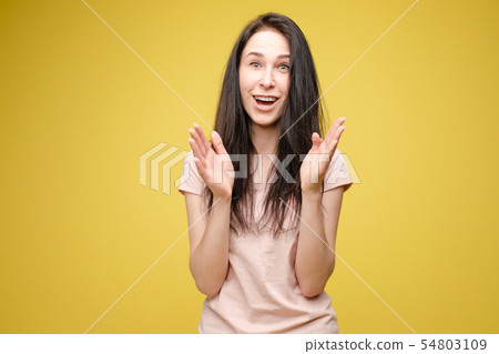Surprised young girl on yellow isolated background Surprised young girl on yellow isolated background 54803109
