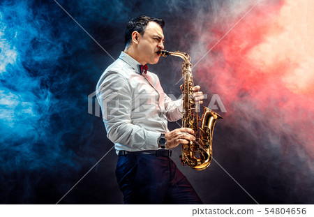 Handsome adult man playing saxophone 54804656