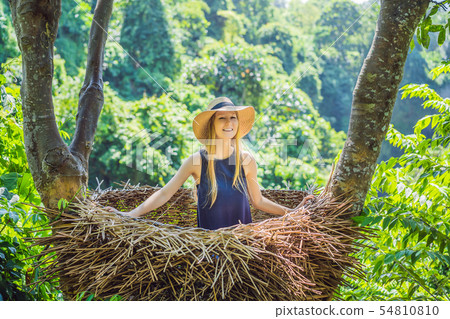 Bali trend, straw nests everywhere. Young tourist enjoying her travel around Bali island, Indonesia Bali trend, straw nests everywhere. Young tourist enjoying her travel around Bali island, Indonesia 54810810