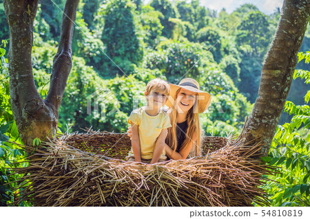 Bali trend, straw nests everywhere. Happy family enjoying their travel around Bali island, Indonesia Bali trend, straw nests everywhere. Happy family enjoying their travel around Bali island, Indonesia 54810819