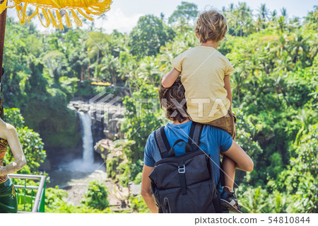 Dad and son tourists on the background of a waterfall. Traveling with kids concept. What to do with 54810844