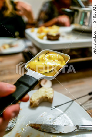 Swiss or Dutch raclette table filled with ingredients for a celebratory evening like Christmas or 54810925