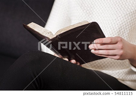 Woman sits and read the bible Woman sits and read the bible 54811115
