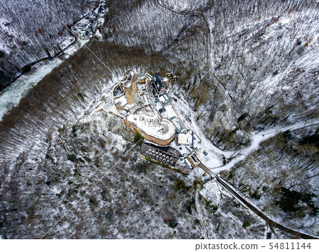 aerial view rock with medieval castle on it near moselle river in Brodenbach winter with forest snow aerial view rock with medieval castle on it near moselle river in Brodenbach winter with forest snow 54811144