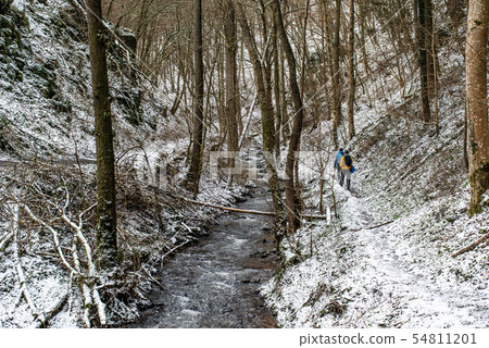 Winter Man hiking trekking in white forest. Travel recreation fitness and healthy lifestyle in Winter Man hiking trekking in white forest. Travel recreation fitness and healthy lifestyle in 54811201