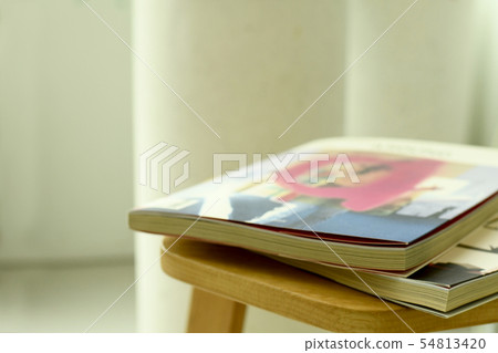 Magazine books on chair Magazine books on chair 54813420