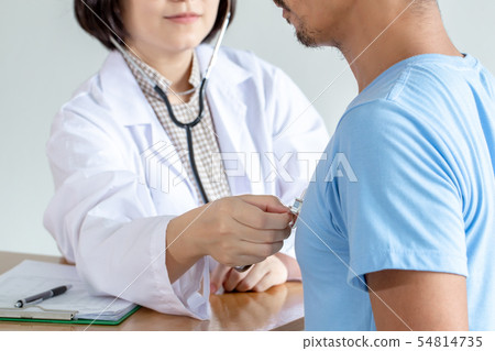 Asian female doctor checking patient heart rate. 54814735