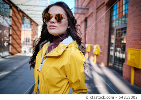 The girl in the yellow coat on the street, stylish The girl in the yellow coat on the street, stylish 54815002