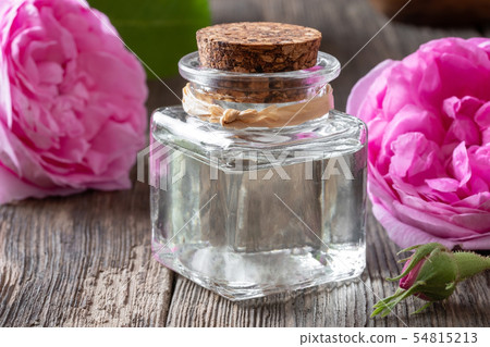 A bottle of rose essential oil with Rose de mai A bottle of rose essential oil with Rose de mai 54815213