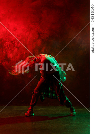 Photo of girl dancing modern dances on red-green background 54816140