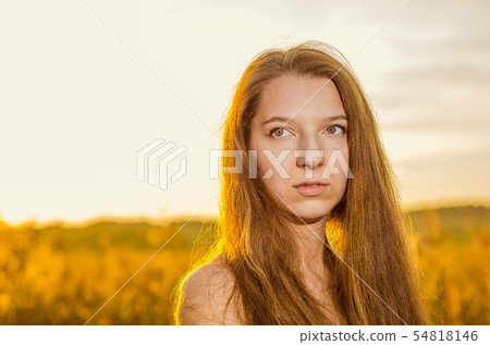 Beautiful girl in a posh red dress posing on a poppy field. Poppy field at sunset. Art processing Beautiful girl in a posh red dress posing on a poppy field. Poppy field at sunset. Art processing 54818146