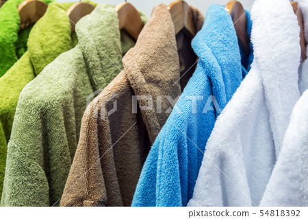bathrobes of different colors hang on a hanger bathrobes of different colors hang on a hanger 54818392